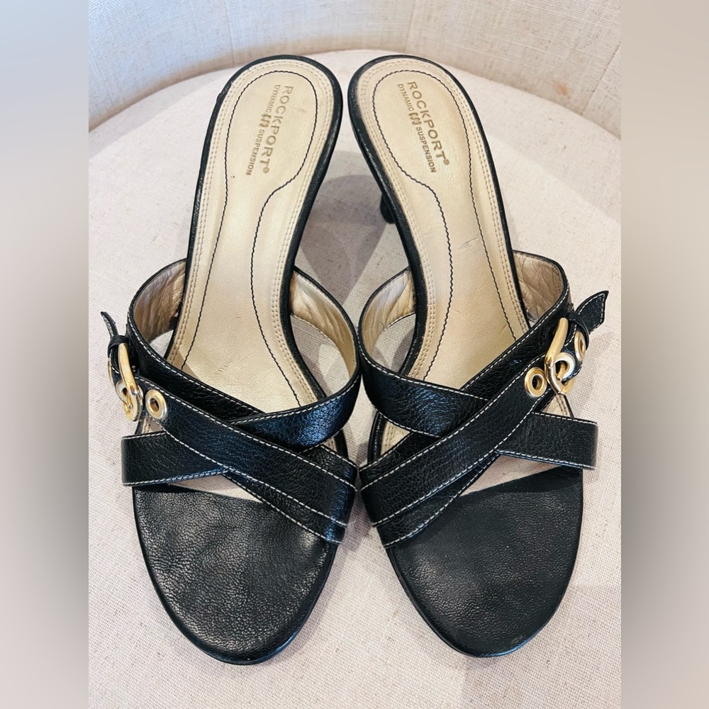 Rockport slide low heel sandal in black leather with gold hardware.